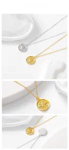 Macro view of gold and silver S925 sterling silver compass pendants on white silk