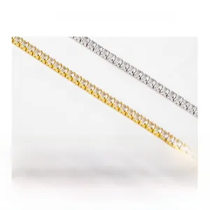 Detailed view of silver and gold plated 4-prong tennis chains with round cubic zirconia