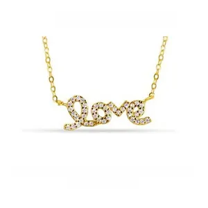 Macro view of gold-plated Love pendant necklace with sparkling pavé cubic zirconia