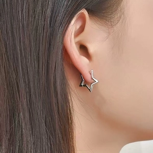Boucles d'oreilles étoiles chic en argent S925 avec finition métallique polie sur modèle