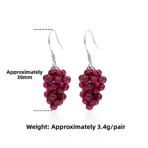 Detail of 925 sterling silver grape cluster earrings with red garnet beads and hooks