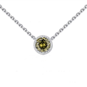 Macro shot of 925 sterling silver necklace featuring an olive green zircon pendant detail