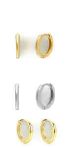 Detailed close-up of polished 925 sterling silver and gold hoop earrings with clicker clasp