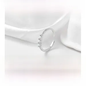 Detailed shot of S925 silver adjustable toe ring with three white opals and zircons