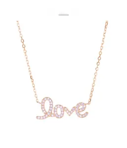 Close-up of rose gold Love pendant with sparkling crystals on a delicate chain