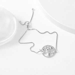 Detail of adjustable silver box chain with tree of life pendant and blue zircons