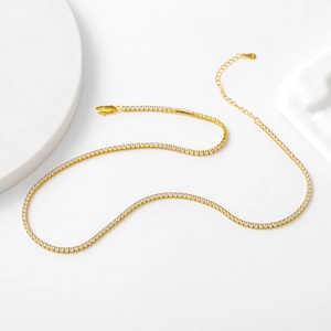 Detail view of gold S925 silver tennis necklace with round zircon stones and lobster clasp