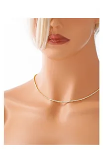 Detail of a thin gold tennis necklace with 4-claw cubic zirconia on a jewelry bust display