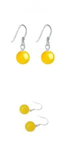 Detail view of ethnic S925 silver ear hooks with polished yellow agate beads on white background