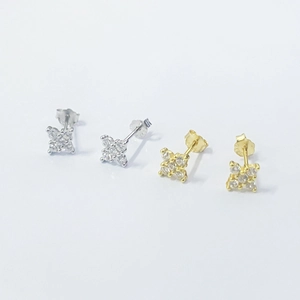 Detail of silver and gold flower stud earrings with sparkling cubic zirconia stones