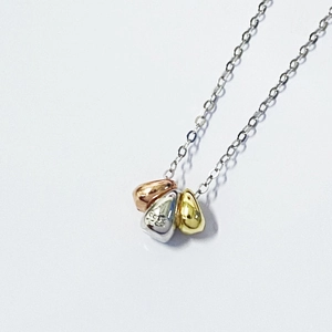 Macro detail of tricolor waterdrop pendant with S925 engraving on silver bean charm