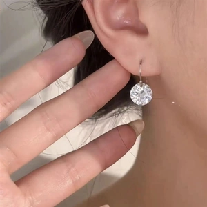 Elegant S925 sterling silver drop hook earrings with a brilliant round-cut zircon on model