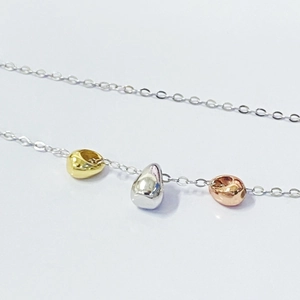 Three-color waterdrop pendant necklace with gold, silver and rose gold beads on thin chain