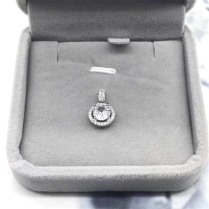 Macro view of a classic round S925 sterling silver halo pendant necklace in a velvet box