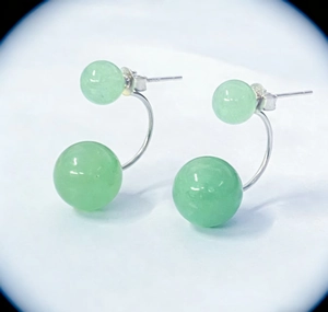 Detail of S925 silver ear studs featuring green aventurine double beads and curved bars