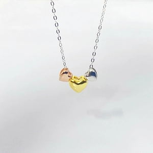 Three-tone heart pendant necklace in gold, silver, and rose gold finish for women