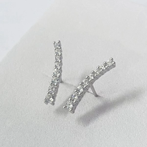 Macro view of curved S925 silver earrings with pavé set cubic zirconia stones