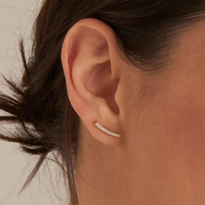 Close-up of elegant S925 silver gold-plated curved earrings with cubic zirconia