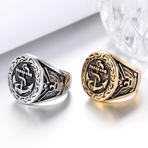 Close-up of vintage steel anchor signet rings with detailed eagle side engravings