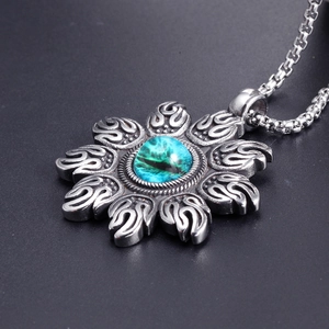 Retro punk sun flame pendant in stainless steel with a blue cat eye gemstone