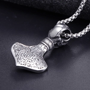 Close-up of Viking Mjölnir pendant with intricate Norse carvings and steel box chain