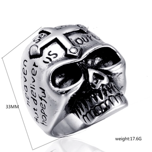 Detail view of gothic skull ring with cross relief and engraved side verses, 33mm height