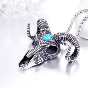 Detail of ram skull pendant with turquoise stone inlay on vintage steel box chain