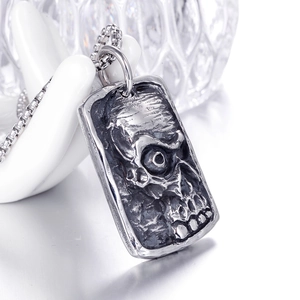 Retro stainless steel mummy skull pendant necklace with vintage finish on a hand model