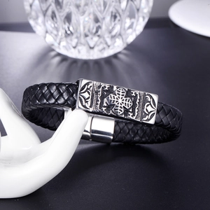 Men's black braided leather bracelet with stainless steel cross plaque on a hand model