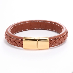 Macro shot of brown braided leather bracelet featuring a smooth gold metallic magnetic clasp