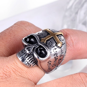 Detailed macro view of skull ring with gold cross and engraved religious prayer text