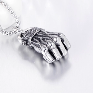 Macro view of vintage titanium steel fist pendant with realistic muscle textures