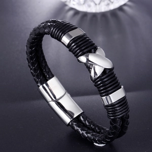 Minimalist black braided leather bracelet with silver X-shaped metal charm and magnetic clasp