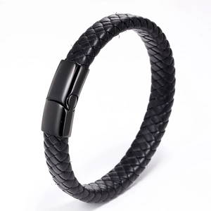 Close-up of braided black leather bracelet featuring a polished black metal magnetic clasp