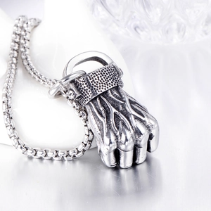 Detailed close-up of retro punk fist pendant with textured finish and box chain