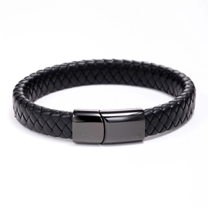 Detailed view of black braided leather bracelet with magnetic polished steel clasp
