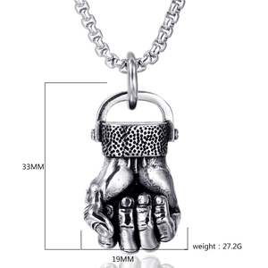 Detail view of a vintage fist pendant necklace with 33mm height and 19mm width measurements
