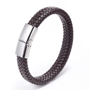 Close-up of brown braided leather texture and polished stainless steel magnetic clasp