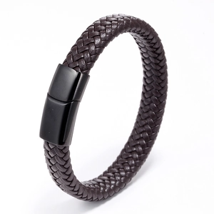 Detail of dark brown braided leather bracelet featuring a matte black magnetic clasp