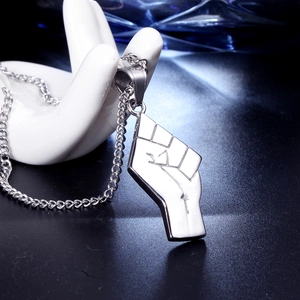 Polished stainless steel clenched fist pendant necklace set on a decorative hand model