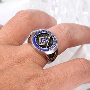 Macro shot of stainless steel Freemasonry ring with blue enamel and G symbol engraving