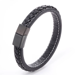 Detail of black braided leather bracelet featuring a matte magnetic metal clasp and white stitching