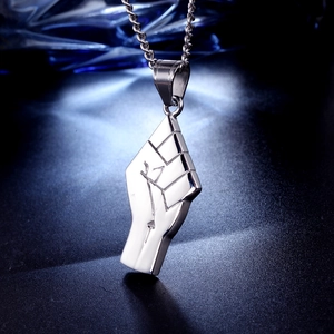 Macro shot of silver stainless steel fist pendant with rune engravings on round chain