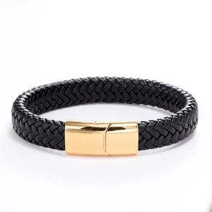 Detailed close-up of black braided leather texture and polished gold magnetic clasp