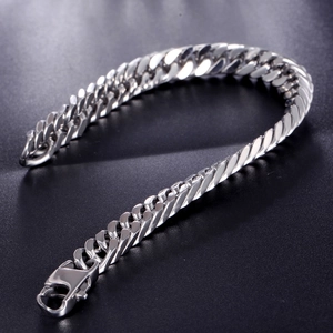 Polished silver Cuban link bracelet for men with secure lobster clasp on grey background