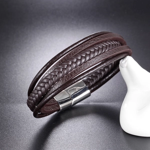 Detail of dark brown multi-layer braided leather bracelet with silver magnetic clasp