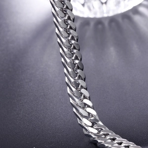 Macro shot of silver titanium steel cuban link bracelet with high polish finish