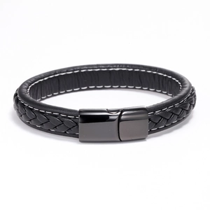 Detail of multi-layer black braided leather bracelet with contrast stitching and metal clasp