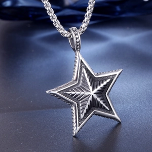 Polished stainless steel pentagram star pendant necklace on elegant blue silk background