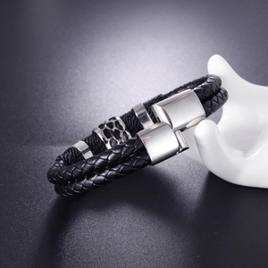 Men's double-wrap braided leather bracelet with magnetic steel clasp on white stand